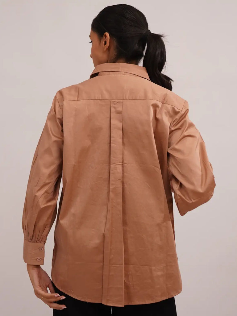 Person wearing a brown jacket 