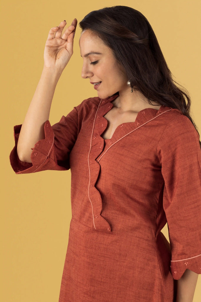 Woman styled in a rust-colored outfit