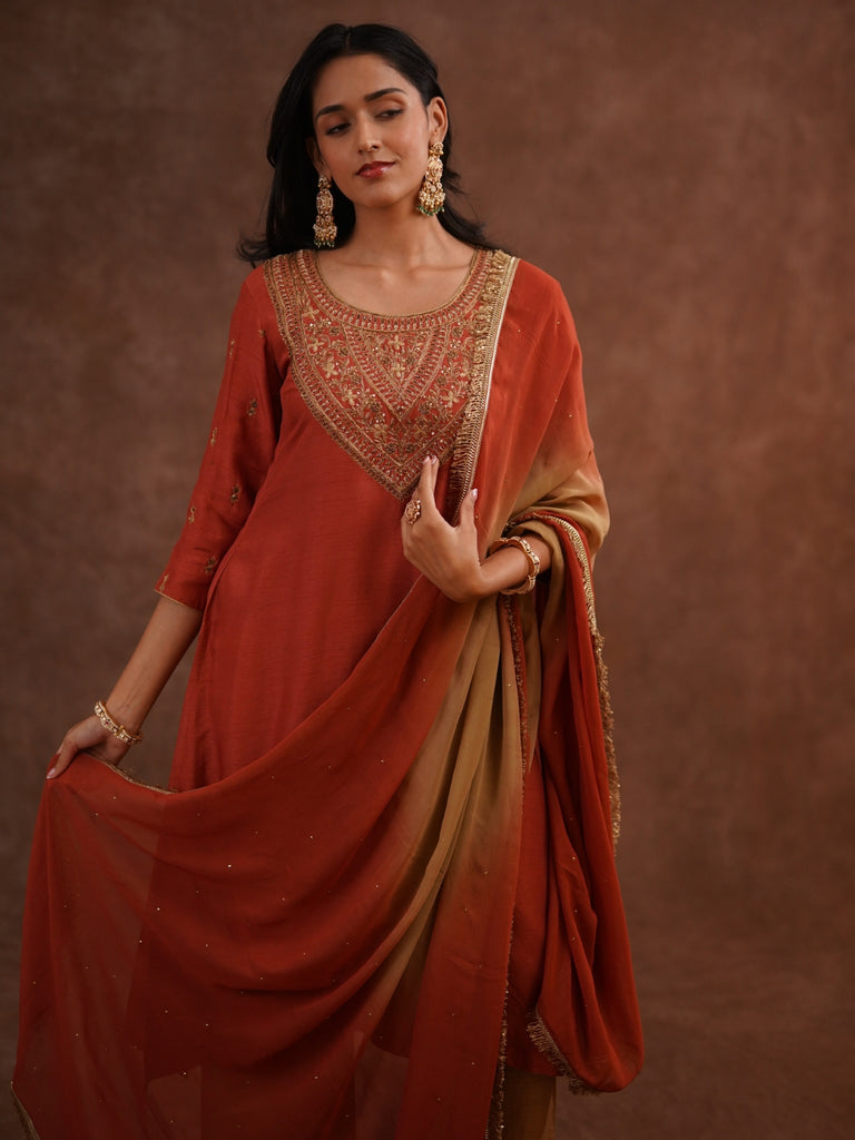Woman wearing a traditional red and gold saree 
